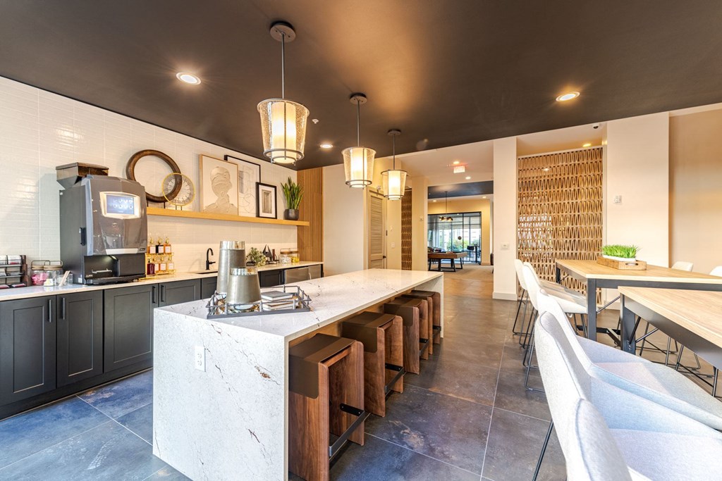 A modern clubhouse with a long island in the middle at The Edison Lofts Apartments, Raleigh, North Carolina