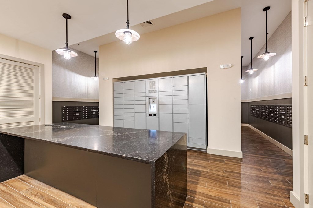 A mail/package room with long counter at The Edison Lofts Apartments, Raleigh, NC, 27601