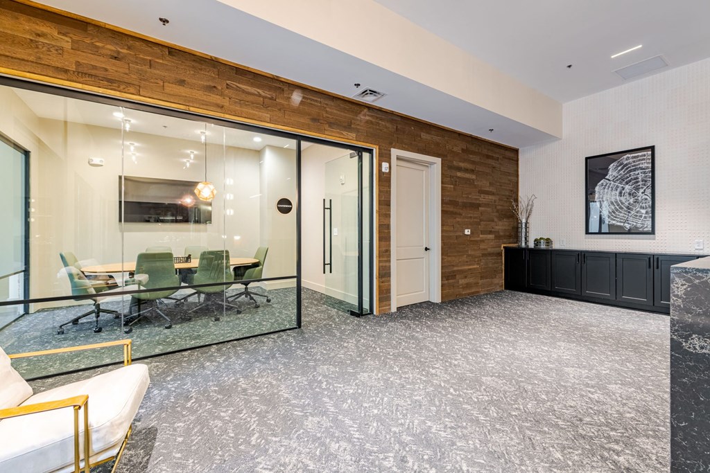 A conference room with a glass table and chairs at The Edison Lofts Apartments, Raleigh, 27601