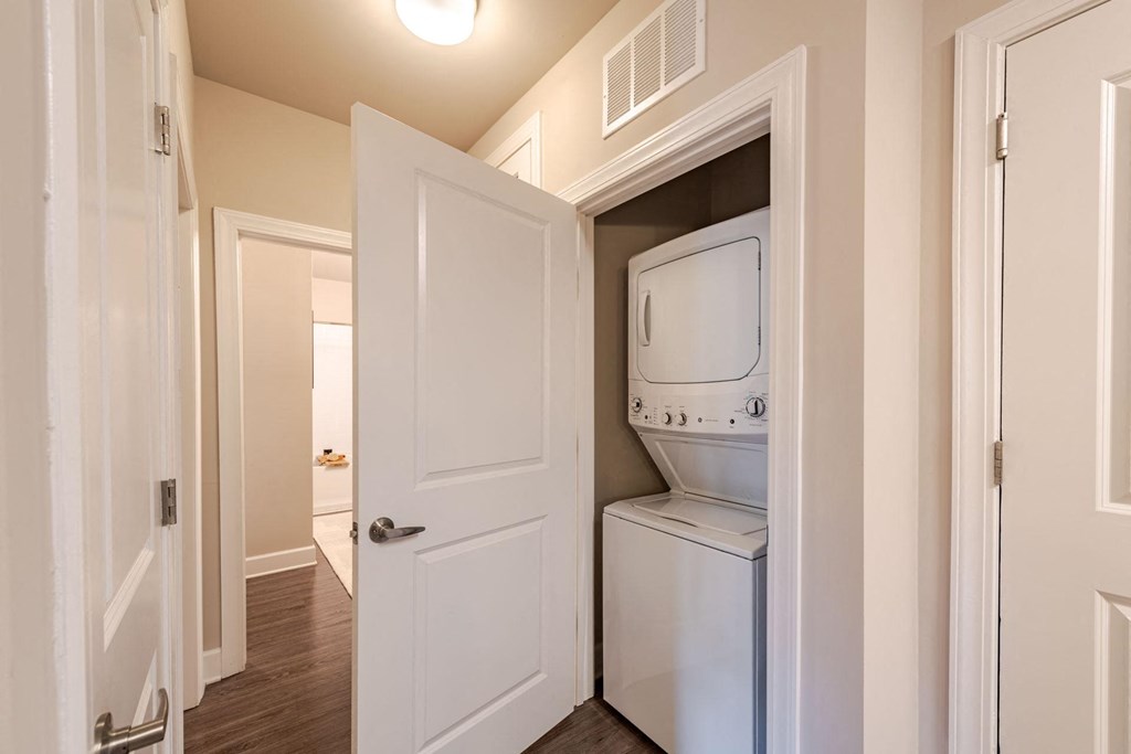 A white door is open to reveal a white dishwasher at The Edison Lofts Apartments, Raleigh, NC