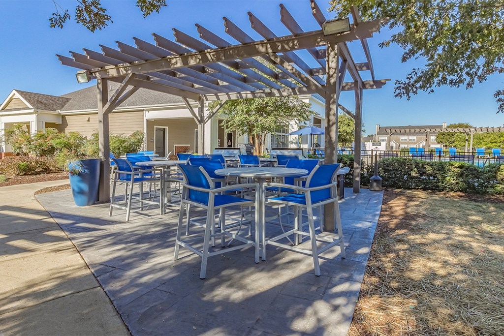 a patio with a pergola and tables and chairs at Fortress Grove, Tennessee