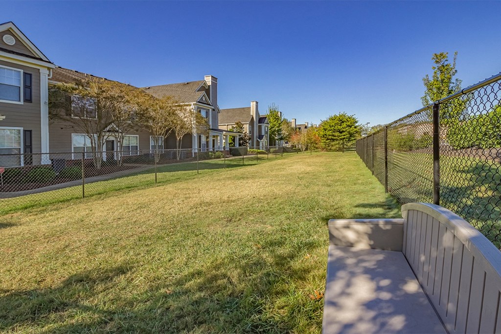 Pet run with green grass, a fence and bench  at Fortress Grove, Murfreesboro, Tennessee