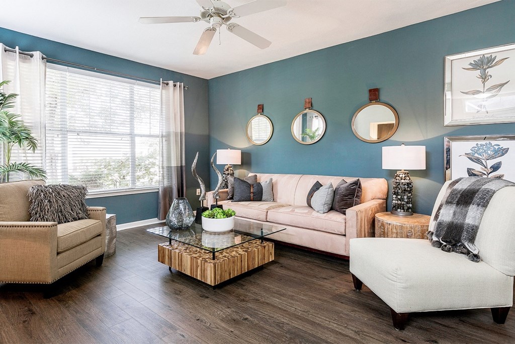 a living room with blue walls and a ceiling fan at Fortress Grove, Murfreesboro, Tennessee