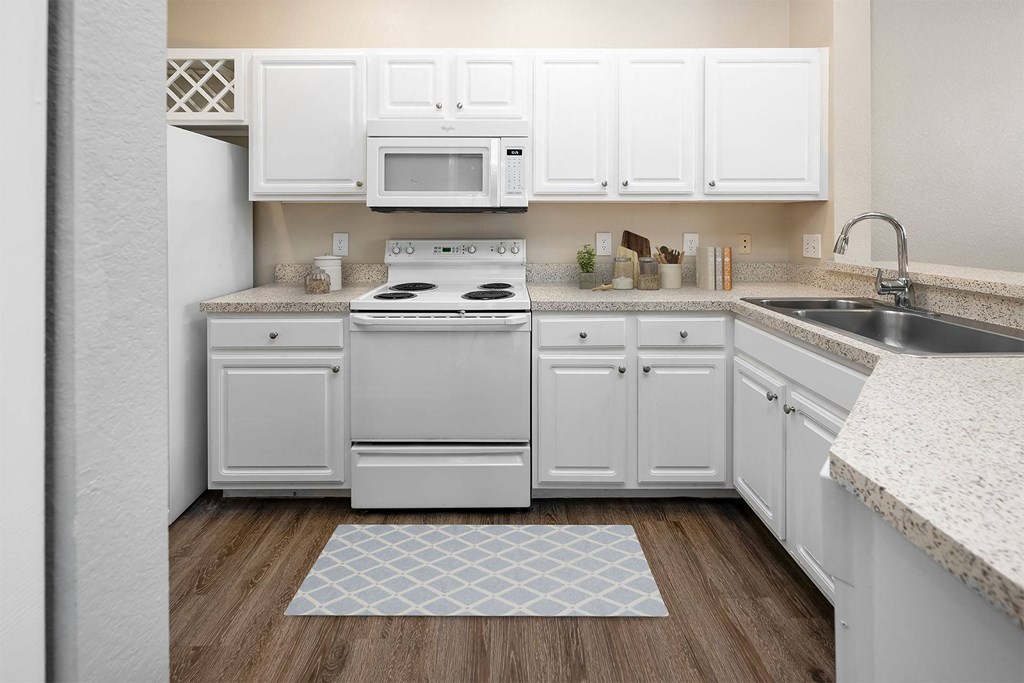 A kitchen with white cabinets at Henley Tampa Palms Apartments, Tampa, Florida