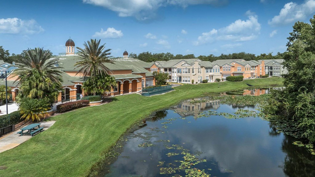 a building with a pond in front of it at Henley Tampa Palms Apartments, Tampa, FL, 33647