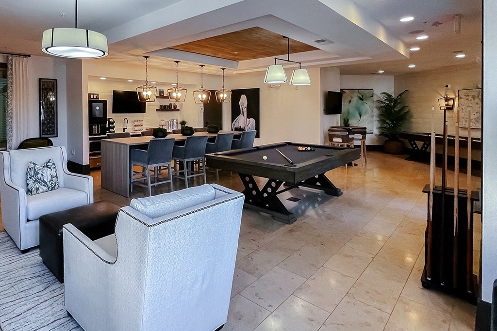 Resident lounge with comfortable chair seating at Two Addison Place Apartments , Pooler