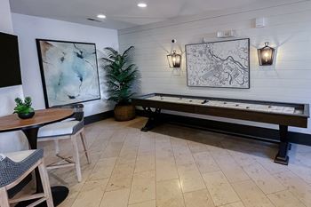 Resident lounge with shuffleboard 1at Two Addison Place Apartments , Pooler, GA