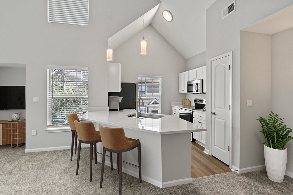 kitchen counter with bar stools and white cabinets at Fortress Grove, Murfreesboro, 37128
