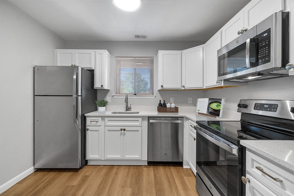 a kitchen with stainless steel appliances and white cabinets at Westwinds Apartments, Annapolis