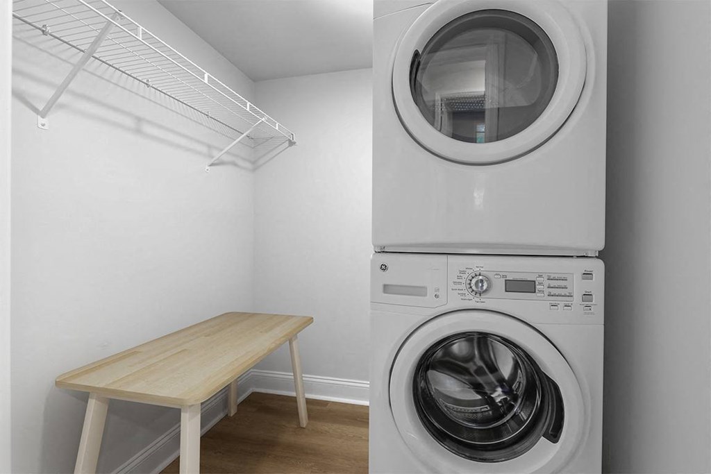 a washer and dryer in a room with a table at Padonia Village Apartments, Timonium MD