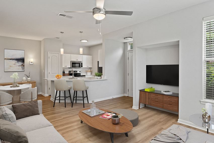 a spacious living room with a kitchen in the background and a ceiling fan in the foreground a spacious living room with a kitchen in the background and a ceiling fan in the foreground at Fortress Grove, Tennessee, 37128