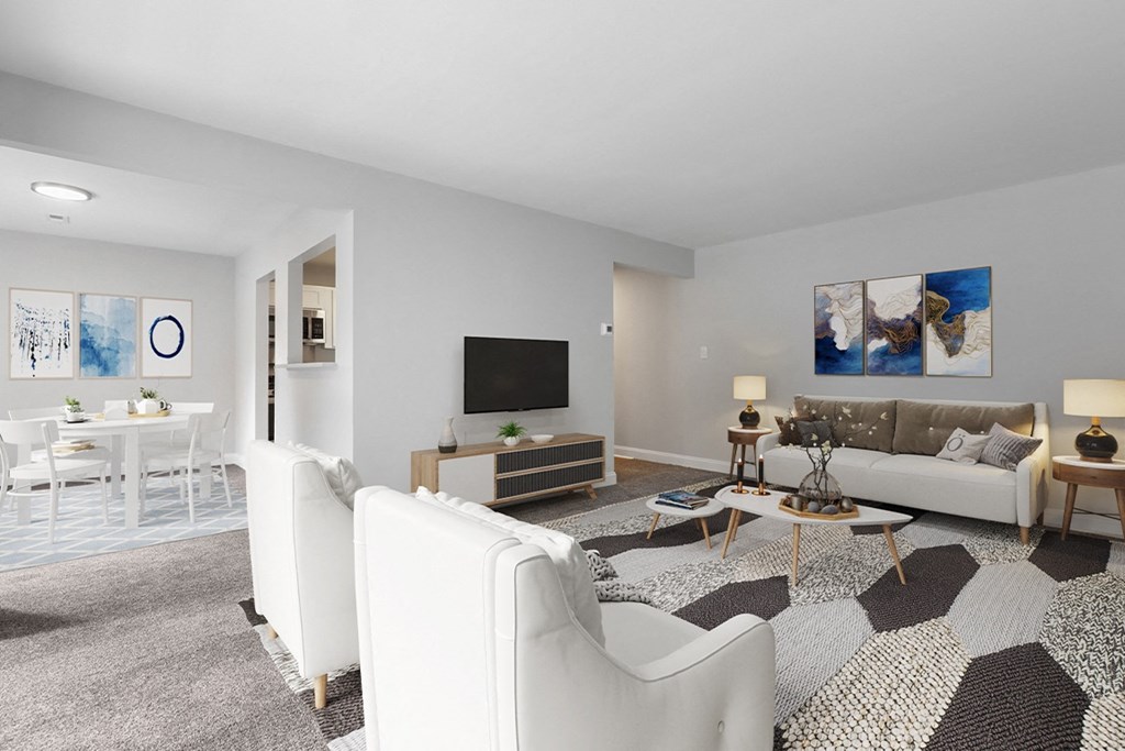 a living room with white couches and chairs and a large rug at Padonia Village Apartments, Timonium MD
