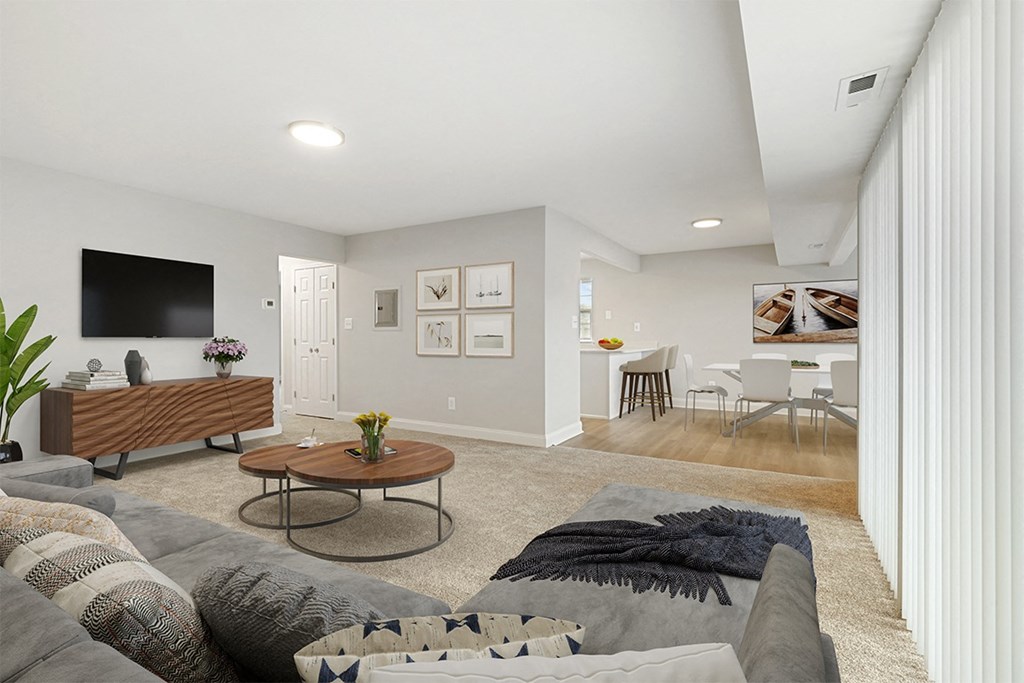 a living room with a couch and a coffee table in front of a flat screen tv, Kenilworth at Perring Park Apartments, Baltimore, MD 21234