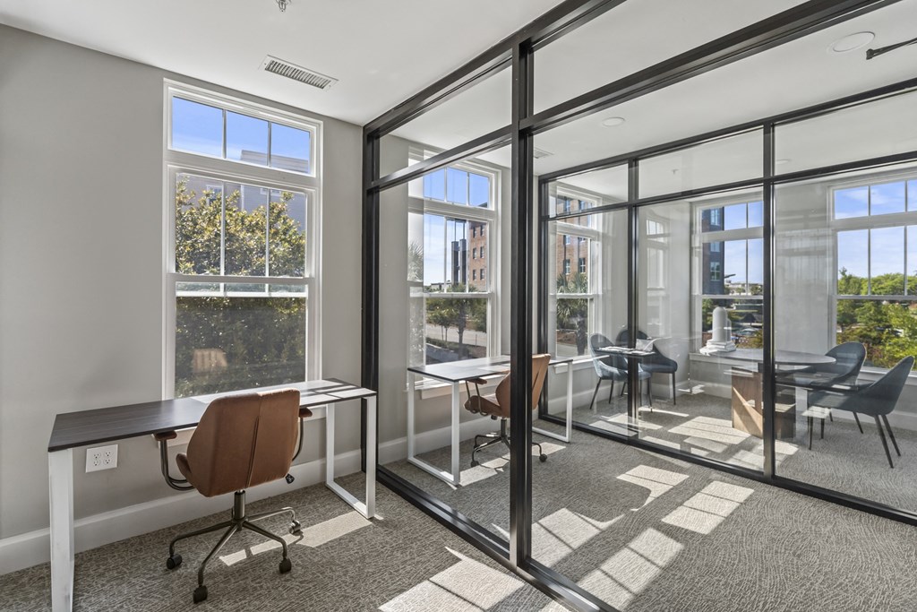 a conference room with glass doors and windows and desks at Central Island Square, Daniel Island, 29492