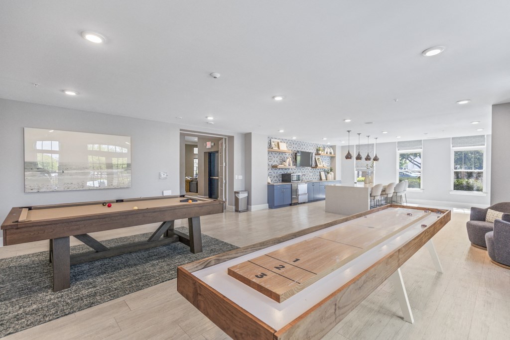 a game room with a shuffleboard table and a pool table at Central Island Square, South Carolina