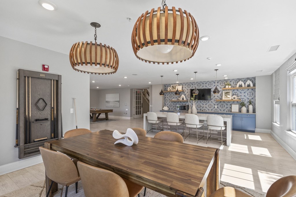 a dining room with a wooden table and chairs at Central Island Square, Daniel Island