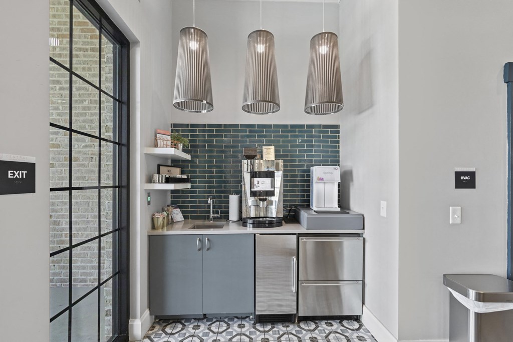 a kitchen with blue cabinets and a coffee maker on the counter at Central Island Square, Daniel Island