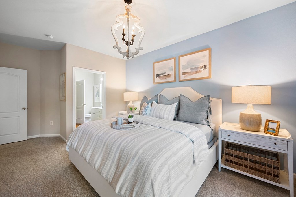a bedroom with a large bed and a chandelier at Sweetgrass Landing, Mount Pleasant, 29466