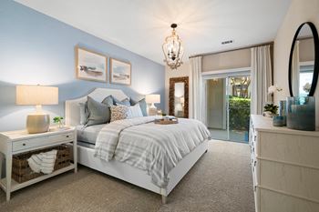 a bedroom with blue walls and a white bed at Sweetgrass Landing, Mount Pleasant, 29466