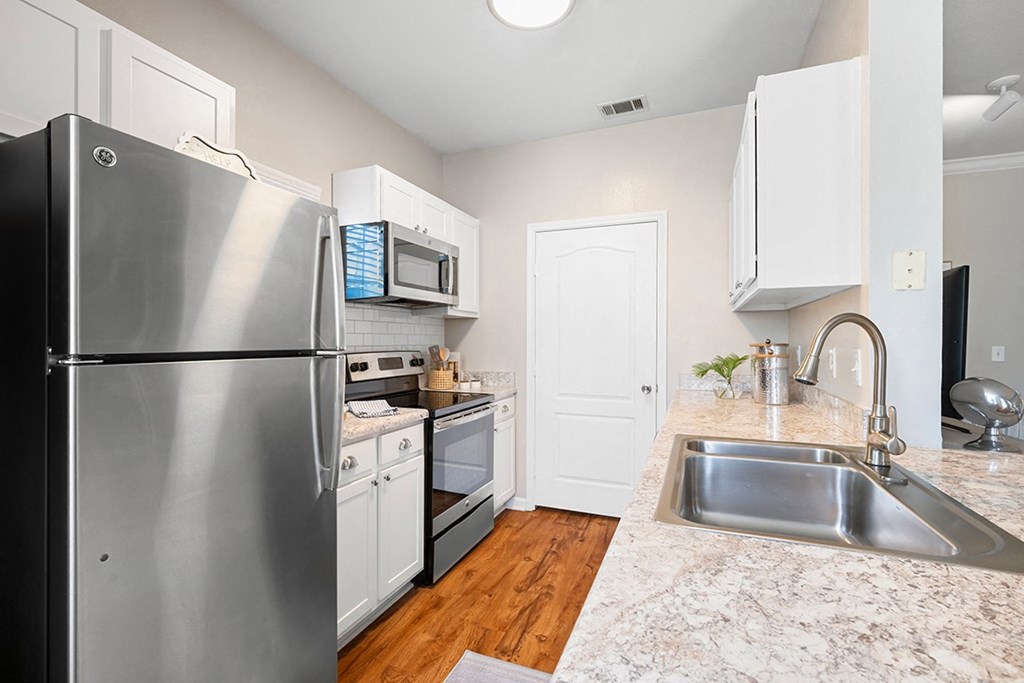 a kitchen with stainless steel appliances and marble counter tops at Sweetgrass Landing, Mount Pleasant, SC