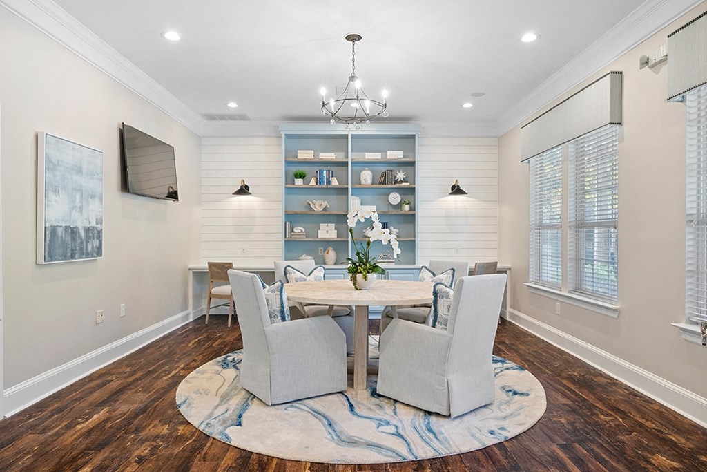 a dining room with a table and chairs and a tv a dining room with a table and chairs and a tv at Sweetgrass Landing, Mount Pleasant, 29466