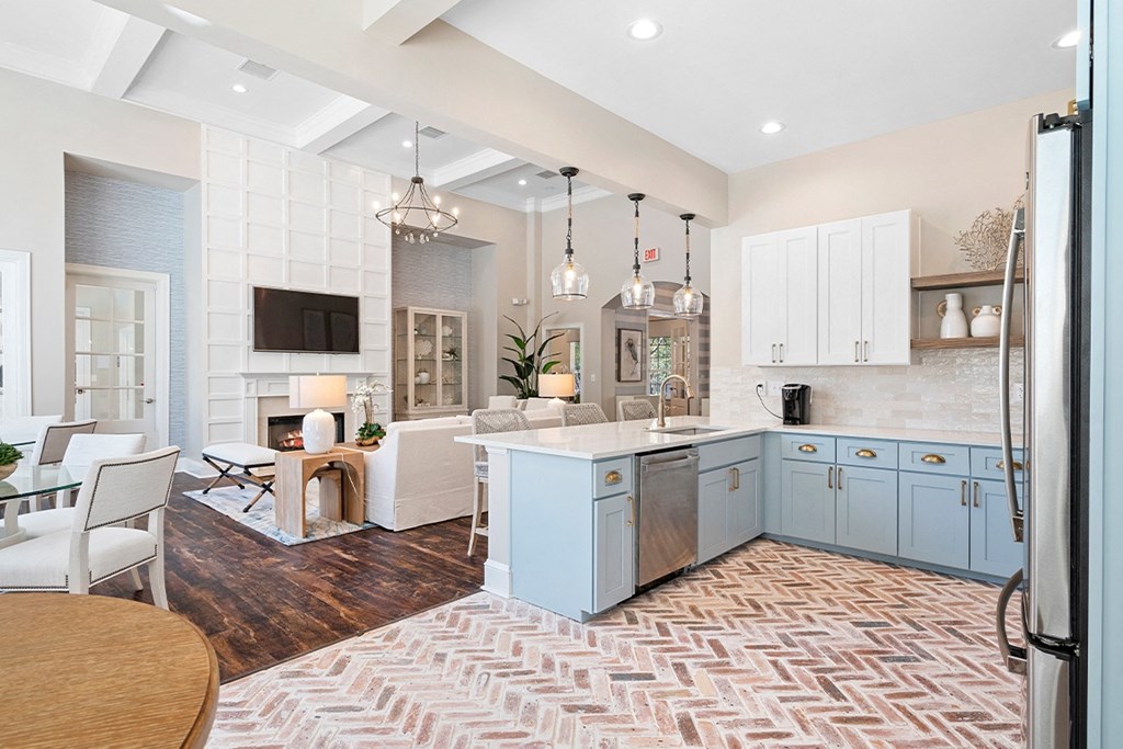 a kitchen with blue cabinets and a living room with a table and chairs at Sweetgrass Landing, South Carolina