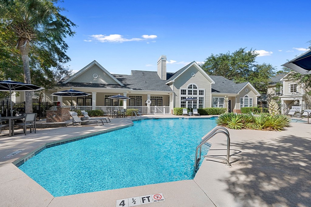 a swimming pool with a house in the background a swimming pool with a house in the background at Sweetgrass Landing, South Carolina, 29466
