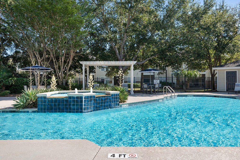 a large swimming pool with a jacuzzi and some trees at Sweetgrass Landing, Mount Pleasant