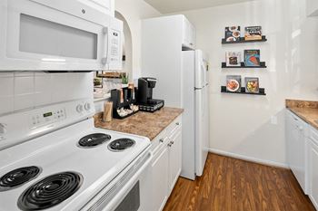 a kitchen with white appliances and a white refrigerator at McDonogh Township Apartments, Maryland