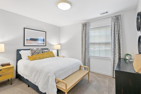 a bedroom with a bed and a window at McDonogh Township Apartments, Owings Mills, MD, 21117