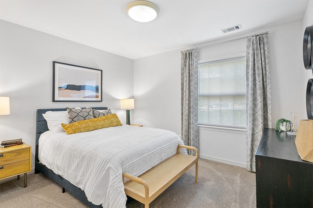 a bedroom with a bed and a window a bedroom with a bed and a window at McDonogh Township Apartments, Owings Mills, MD, 21117