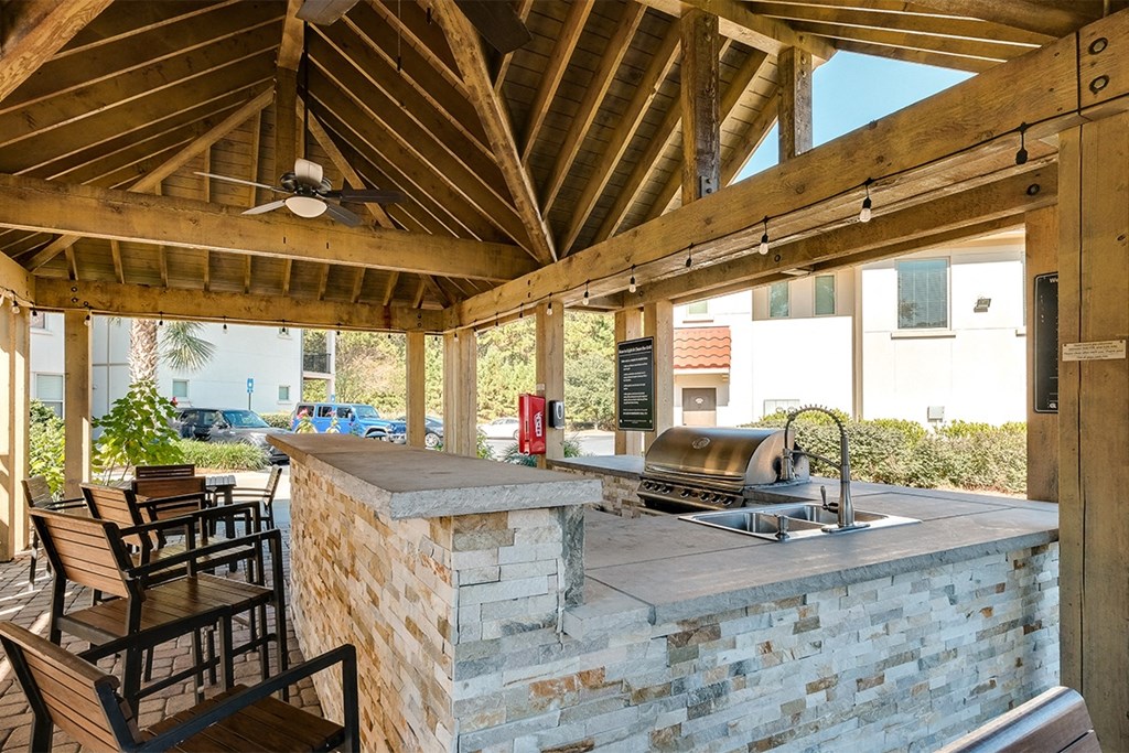 Outdoor grilling pavilion with bar counter seating at Two Addison Place Apartments , Pooler, GA