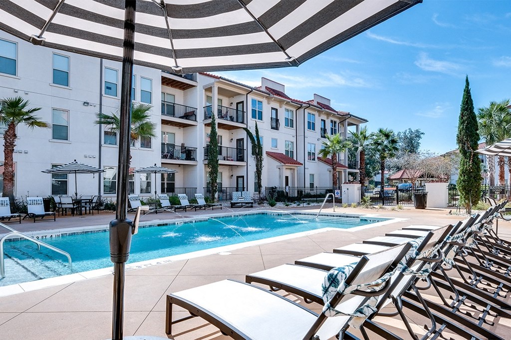 Swimming pool deck with chaise lounge   at Two Addison Place Apartments , Pooler, GA, 31322