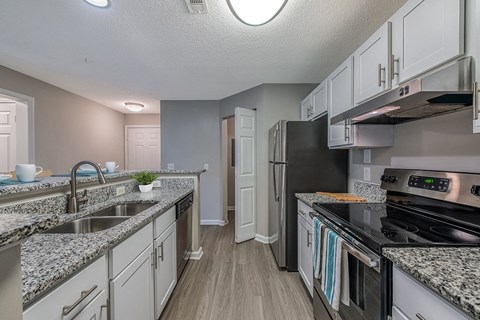an open kitchen with granite counter tops and stainless steel appliances