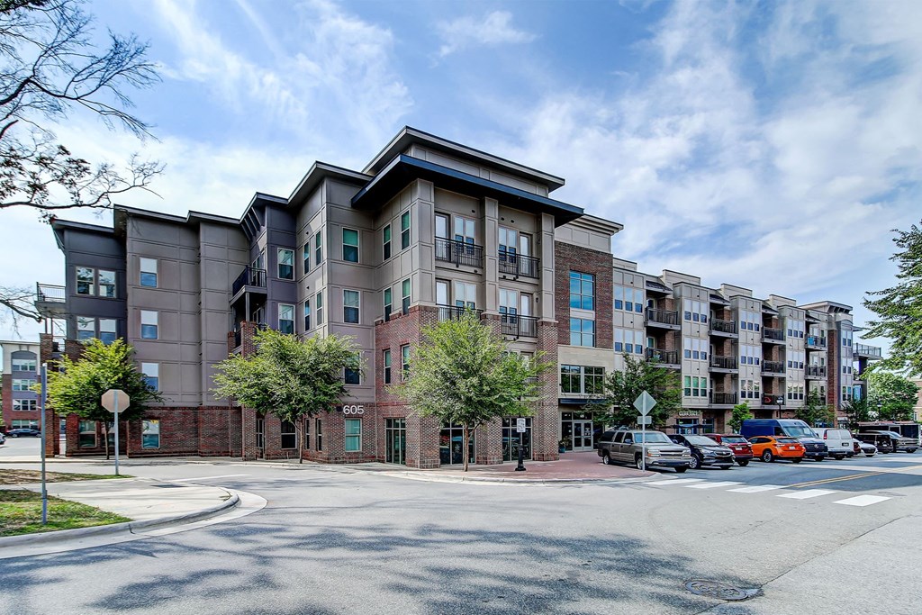 Apartment building exterior with cars parked in front at The Linden Apartments, Davidson, North Carolina