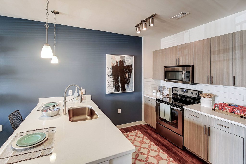 A kitchen with a white counter top and a sink at The Linden Apartments, Davidson, NC, 28036