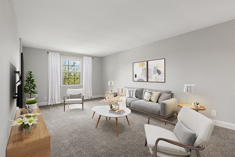 a living room with a couch and chairs and a table