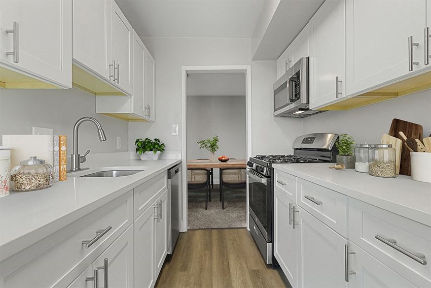 a kitchen with white cabinets and stainless steel appliances  at Courthouse Square Apartments, Towson, MD, 21286