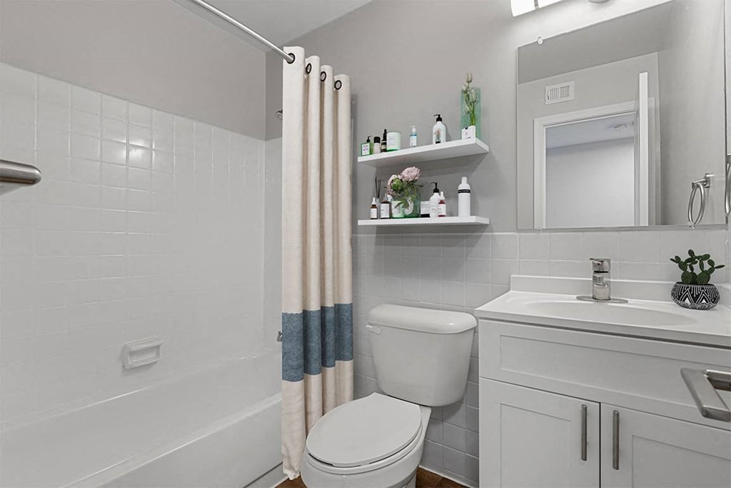 a bathroom with a toilet sink and bathtub  at Courthouse Square Apartments, Towson, MD