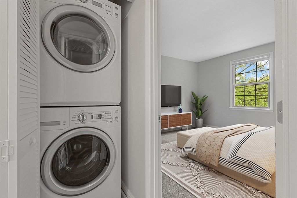 a bedroom with a washer and dryer  at Courthouse Square Apartments, Maryland