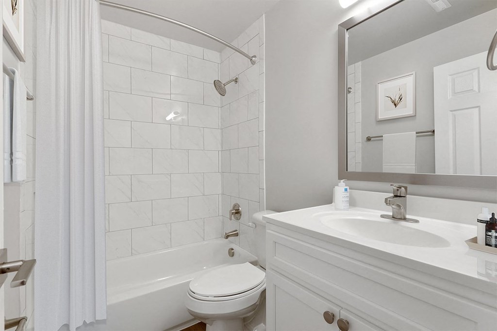 a bathroom with a bathtub and a sink Kenilworth at Perring Park Apartments, Baltimore, MD 21234