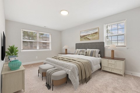 a bedroom with a bed and two windows Kenilworth at Perring Park Apartments, Parkville, MD 21234