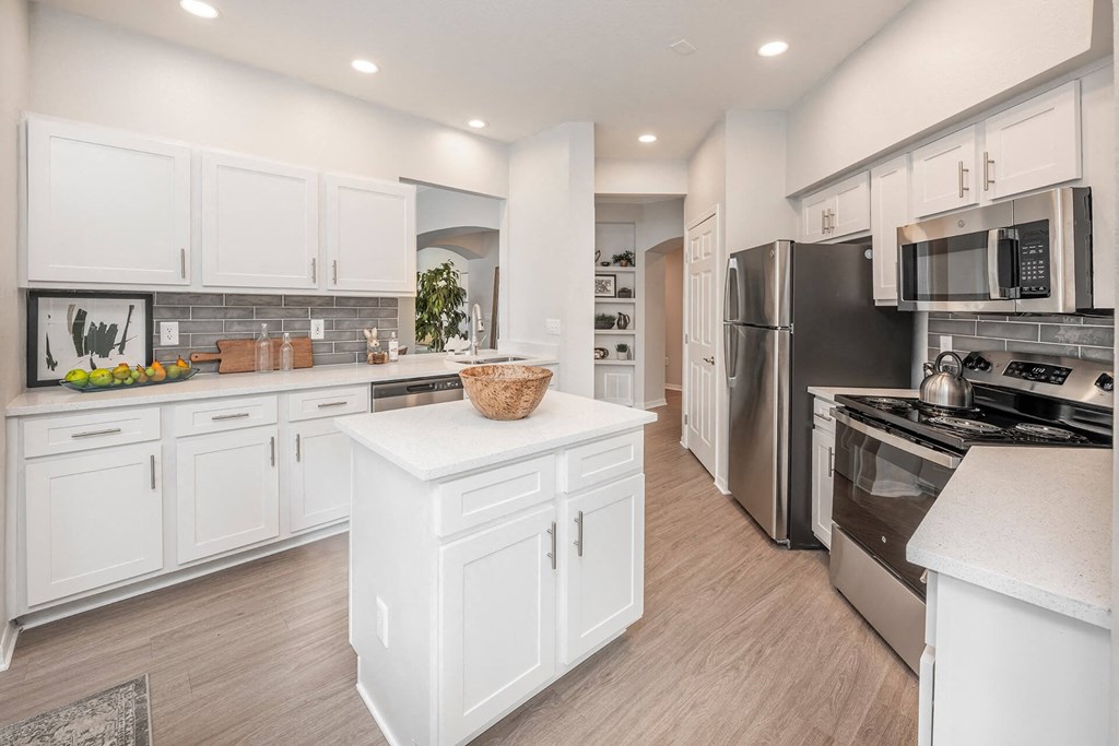 a large kitchen with white cabinets and stainless steel appliances at Henley Tampa Palms Apartments, Tampa, FL, 33647