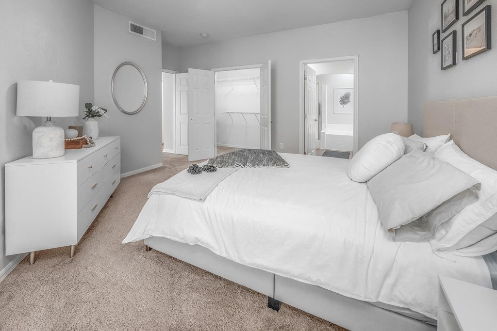 a white bedroom with a white bed and a white dresser at Henley Tampa Palms Apartments, Florida, 33647