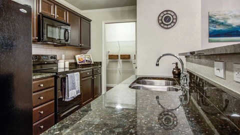 a kitchen with granite counter tops and a sink