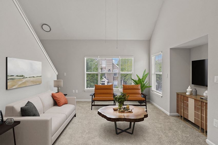 a living room with a white couch and a coffee table in front of a large window a living room with a white couch and a coffee table in front of a large window at Fortress Grove, Murfreesboro
