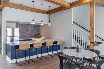 a kitchen with a blue island and a table with chairs at Bristol at New Riverside, Bluffton, SC 29910