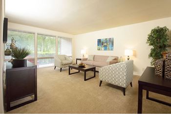 Spacious Living Room With Plush Carpeting at Brook View Apartments Baltimore MD 21209