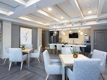 Community lounge with tables and chairs at St Mary's Square North Apartments, Raleigh, NC - Photo Gallery 30