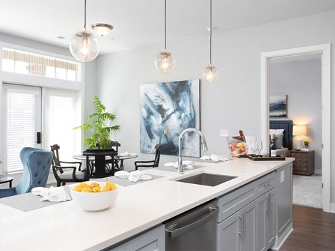 a kitchen counter with a bowl of fruit and a sink